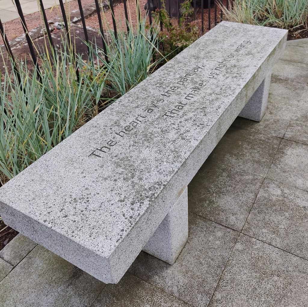 Stone bench with inscription that reads "The heart ay's the pam ay, That makes us right or wrang"