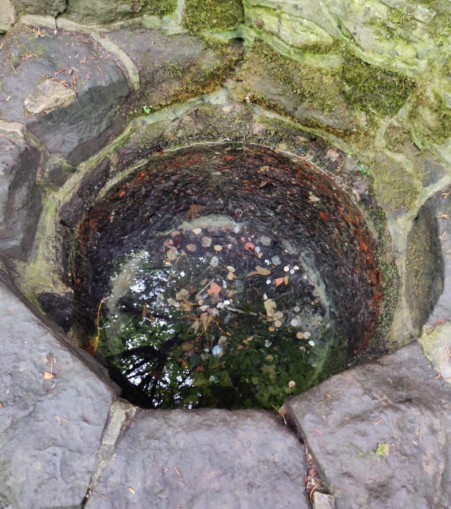 Wishing well with coins